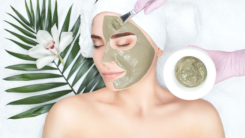 A woman receiving a mud mask treatment.