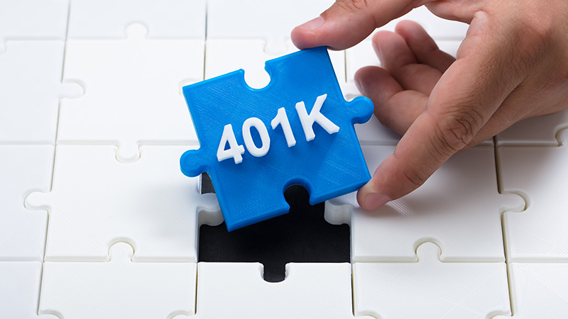 Person placing a 401k piece into a puzzle.