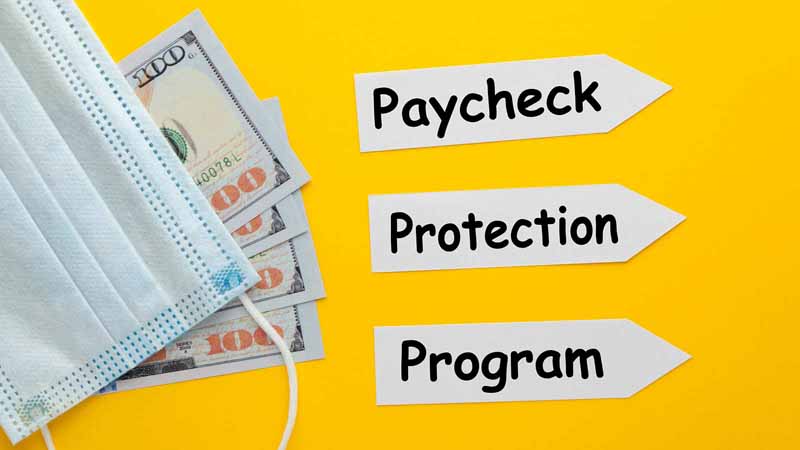 Paycheck Protection Program written next to surgical masks and money.