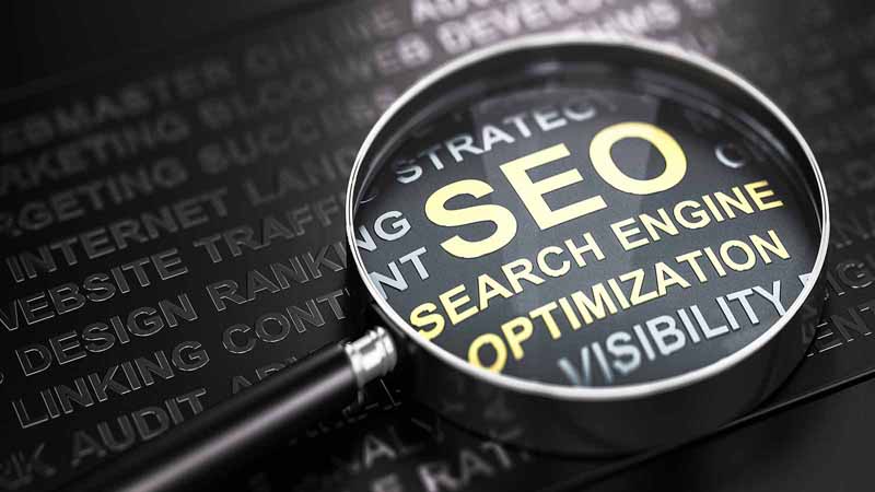 Magnifying glass highlighting 'search engine optimization.'