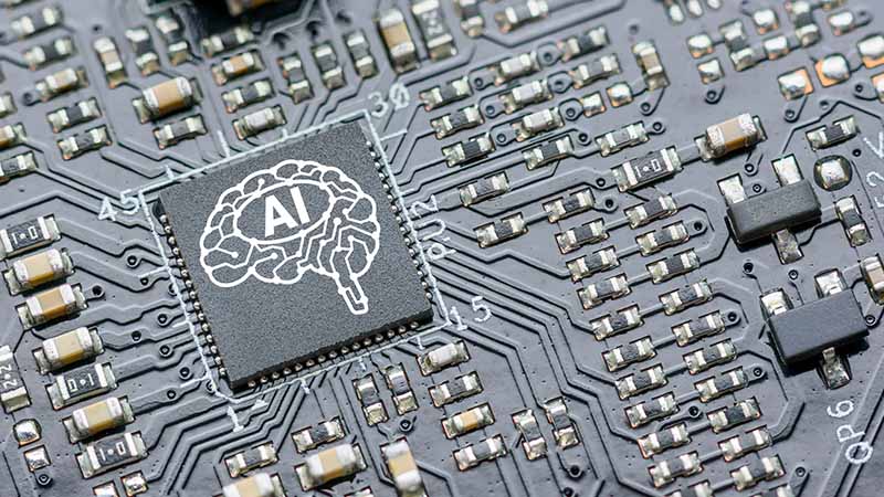 Computer chip with a brain graphic that says "AI."