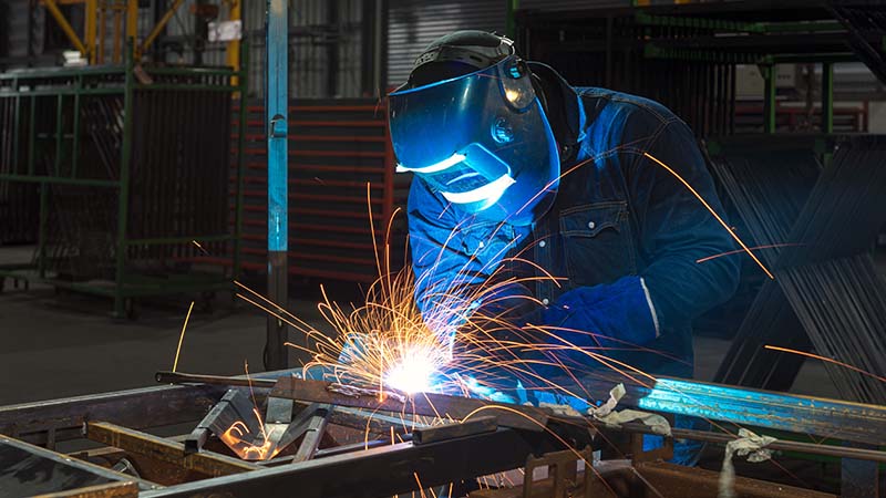 An industrial welder working on a project.