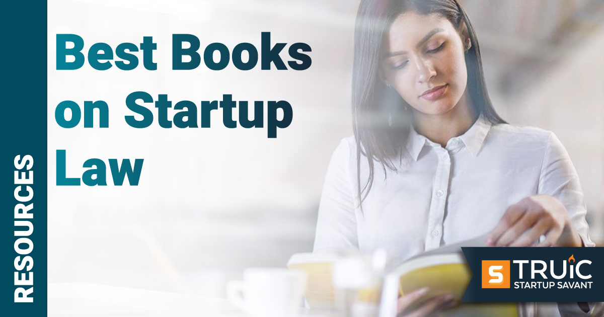 Woman reading book on Startup Law.