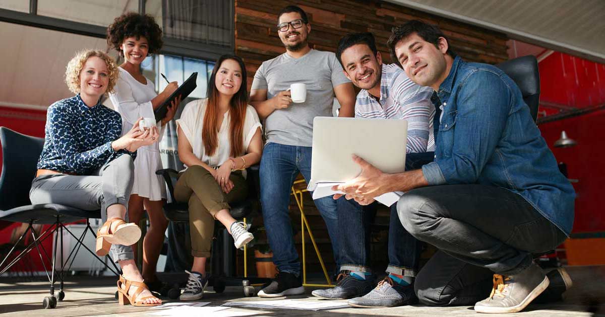 Group of entrepreneurs posing in office.