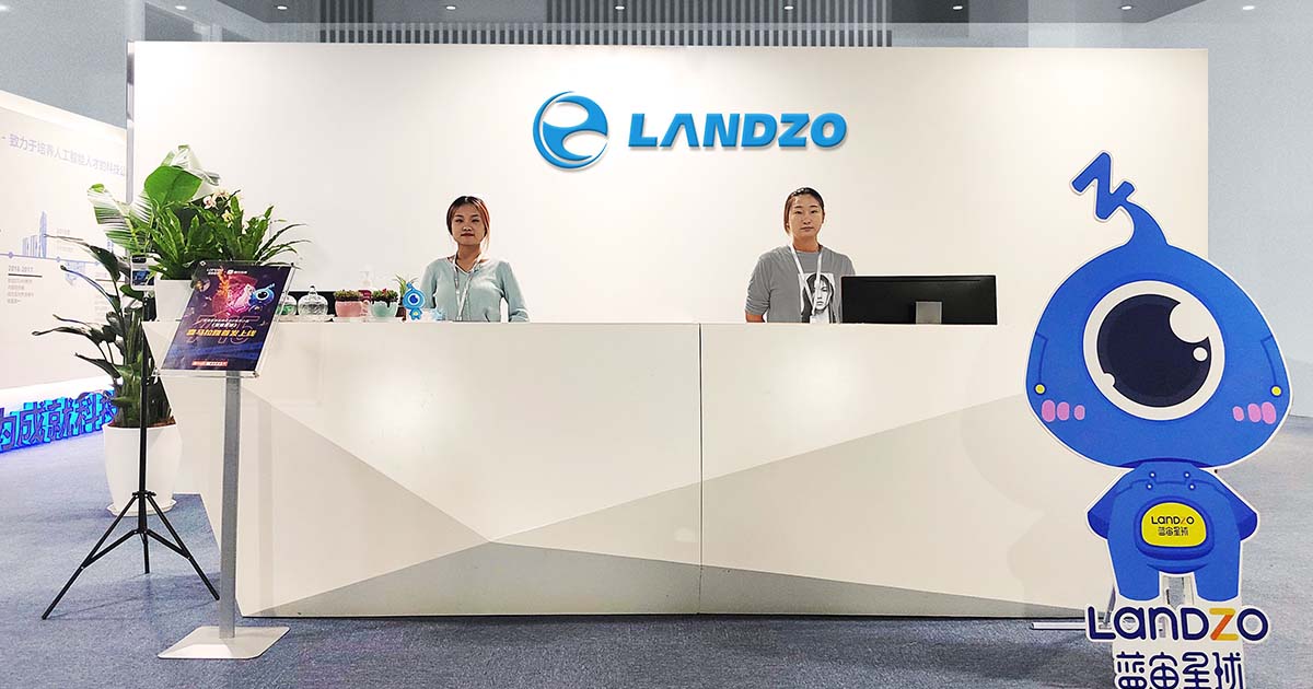 Landzo's office with businesswomen at the front desk.