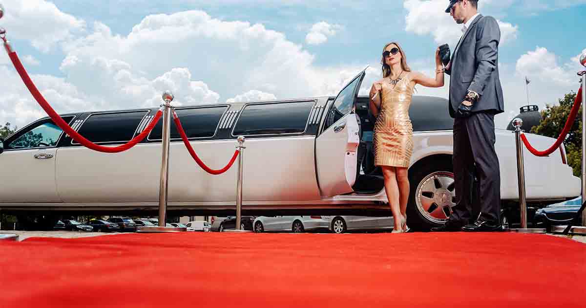 A celebrity leaving a limo to walk the red carpet.