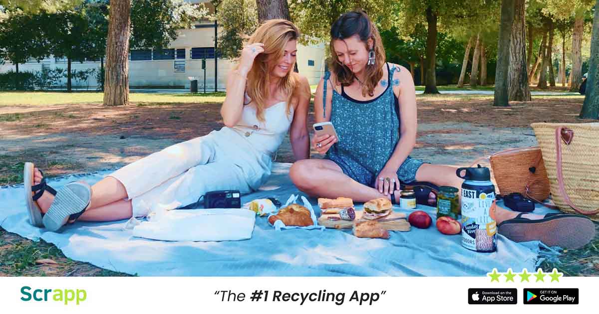 Scrapp graphic with two women during a picnic on a phone, with text saying, "Scrapp, the #1 recycling app."