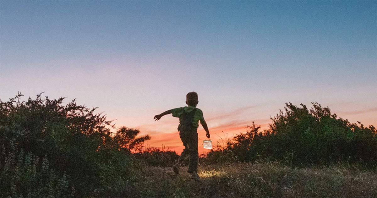 MPOWERD's Luci Light being carried by a child at sunset.