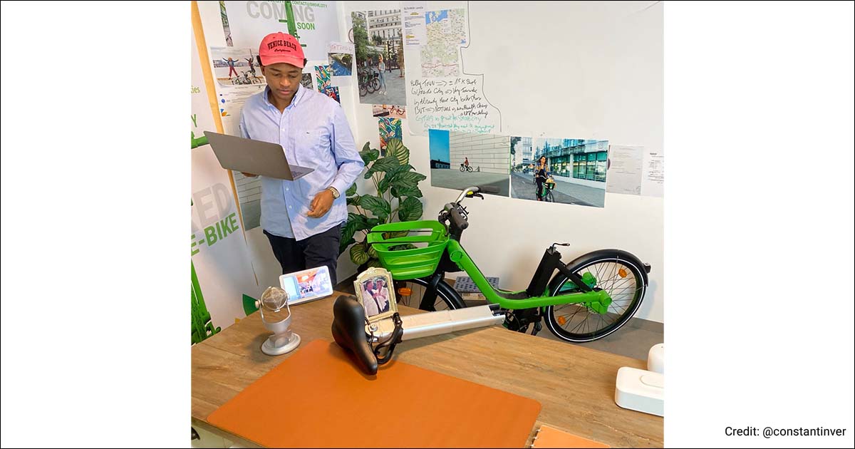 SMOVE.CITY founder working in his office, next to an e-bike.