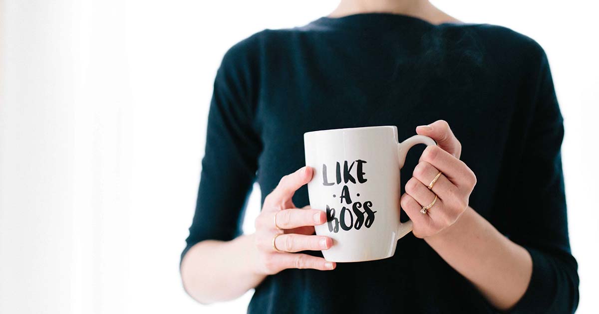 Woman holding "Like a Boss" mug.